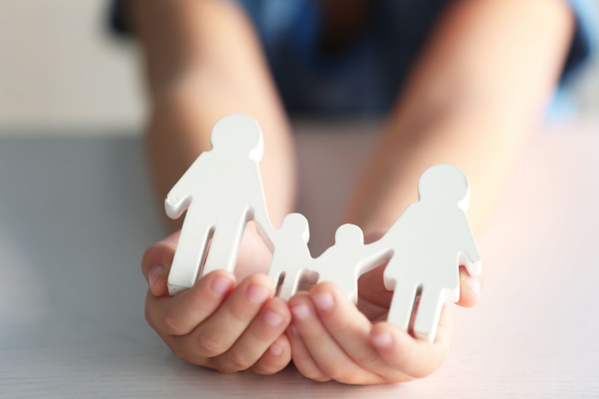 child holding a 3d model of a family