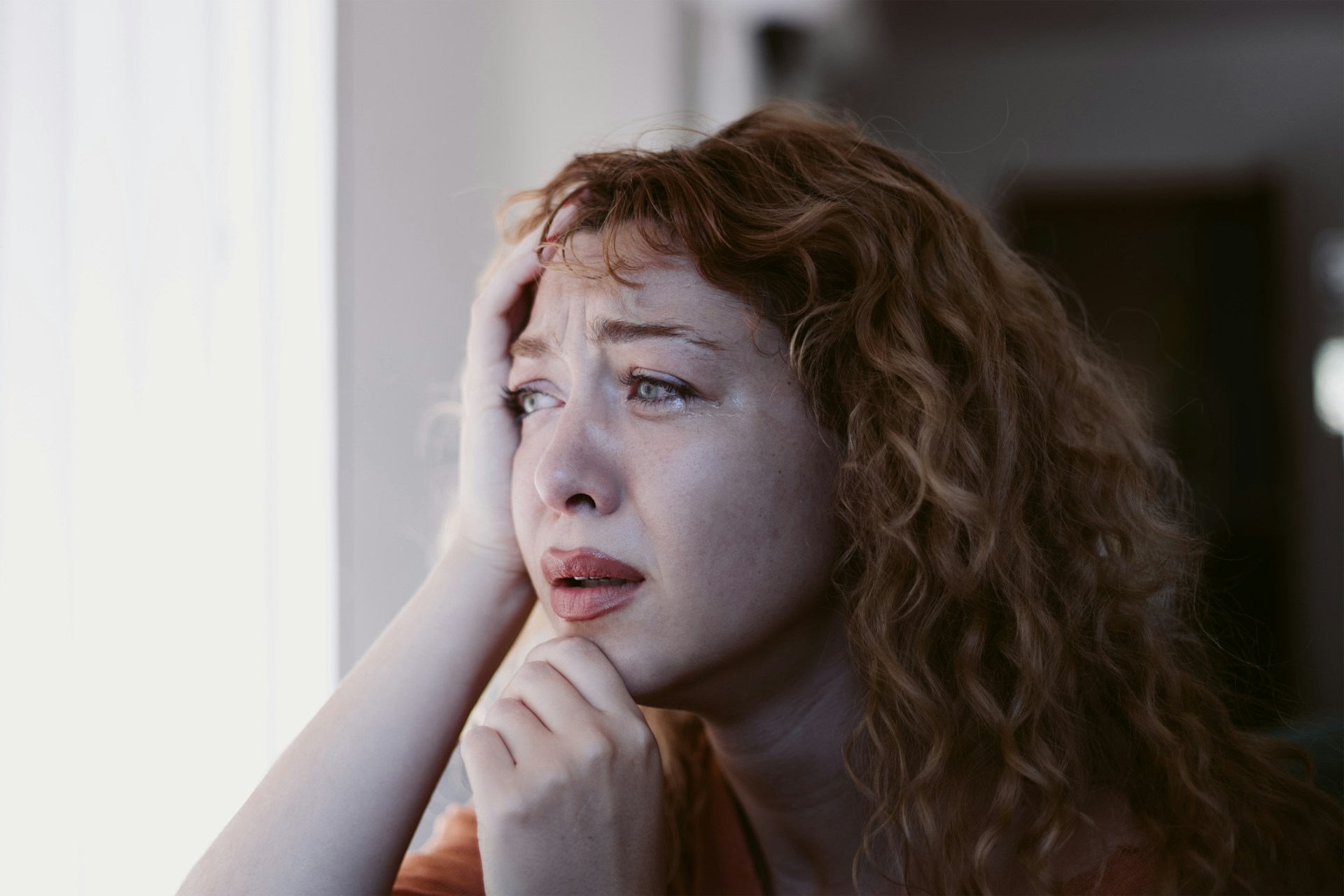 Woman experiencing emotional distress, reflecting on challenges, relevant to coping with accidents in Arizona.