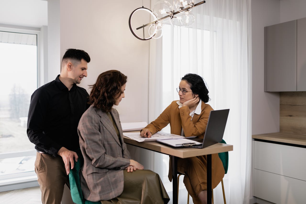 Mesa attorney consulting with clients at Rowley Chapman Barney law firm, discussing legal documents in modern office setting.