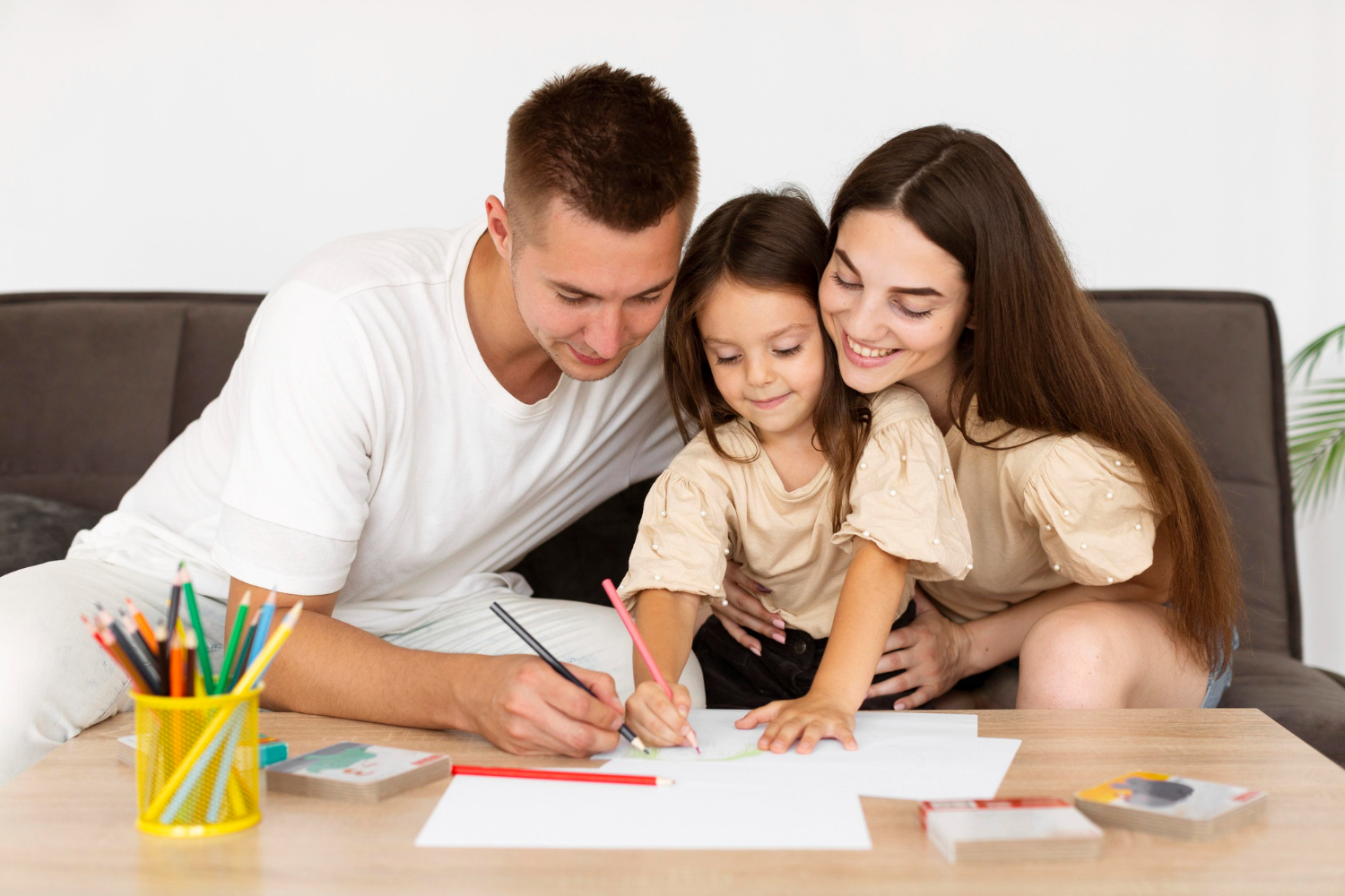 Creating a Comprehensive Estate Plan for Young Families Family engaged in creative activity at home, illustrating the importance of estate planning for young families in Arizona.