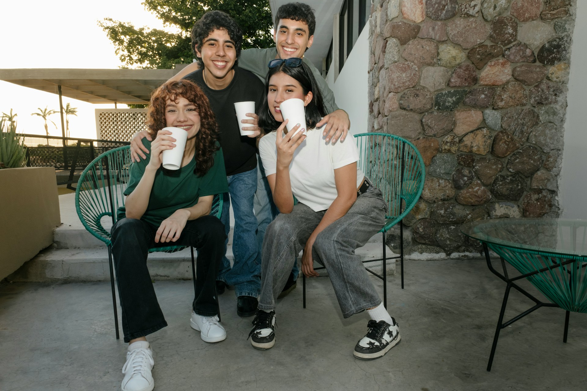 Group of four friends enjoying drinks outdoors in Mesa, Arizona, highlighting community and social connections.